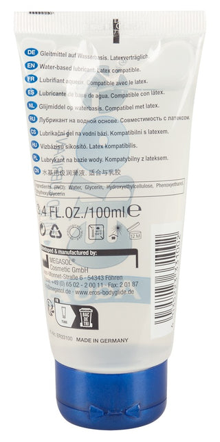 Baksidan av en 100 ml vit tub med glidmedlet EROS Aqua, med blått lock och text på flera språk.