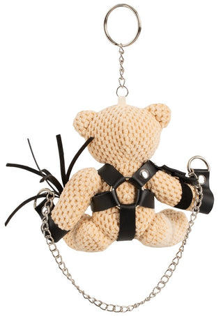 BDSM Nalle i Mini-Gunga är en virkad nyckelring med en teddybjörn i en svart lädersele och kedjor, vänd bakåt - en perfekt quirky samlarfavorit för alla samlingar.