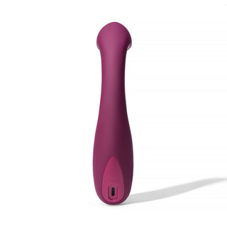 Dame Arc G-punktsvibrator, en lila vattentät vibrator med böjd topp för klitorisstimulering, visas stående vertikalt mot vit bakgrund.