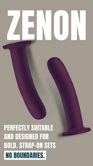 Två lila Zenon-dildos av silikon med sugkoppsfästen, vinklade mot en grå bakgrund.