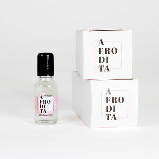 Roll-on-flaska i klarglas med en Feromonparfym-etikett bredvid två vita produktlådor med märke, 20 ml kapacitet.