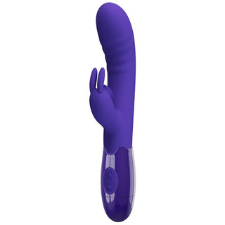 Cerberus Licking Rabbitvibrator är en lila silikonvibrator med ett böjt skaft för G-punktstimulans, en extern stimulator för klitorisstimulans och två kontrollknappar.