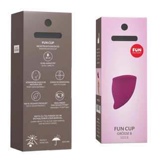 Två askar Fun Cup Menskopp B, tillverkade av medicinskt silikon, med produktinformation och illustrationer på framsidan. Det hypoallergena materialet ger komfort och säkerhet.
