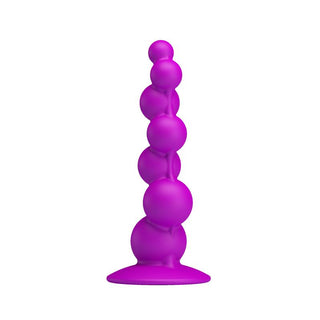 Analplugg i lila silikon med pärlmotiv och sugpropp, 17 cm lång, visas upprätt mot vit bakgrund.
