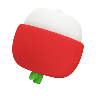 Kompakt massageapparat som liknar ett äpple, med röd bas, vit topp, gröna blad och slät plastkonstruktion.