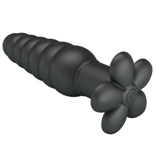 Svart analplugg i mjuk silikon med blomformad ände och 10 vibrationslägen, fotograferad mot vit bakgrund.