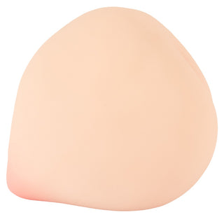 Ljusbeige, persikformad onaniprodukt tillverkad av mjukt, hudliknande material.