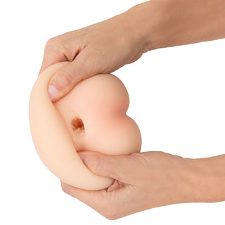 Beau Cœur Felyra Peach-masturbator i persikofärgat silikon med en synlig, strukturerad inre öppning.