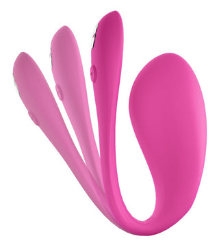 Tre WeVibe Jive 2 rosa personliga massageapparater i silikon, med en ergonomiskt utformad vibrokula, är arrangerade i olika positioner på en vit bakgrund.
