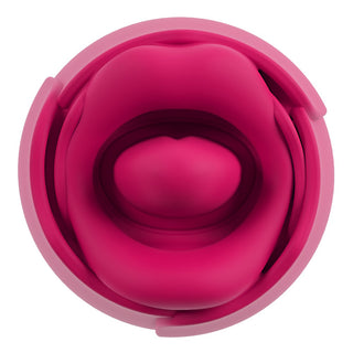 Ljusrosa tungvibrator i silikon med kronbladsformade kurvor och en upphöjd central kupol, sedd uppifrån.