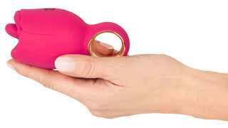 Rosa rosformad klitorisstimulator med handtag i guldring; silikonmaterial och modern design.