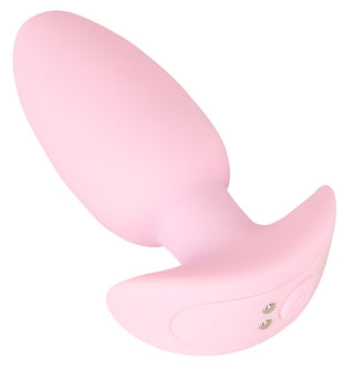 Cuties Mini Vibrating Plug är en rosa, uppladdningsbar analplugg i silikon med kontrollknappar och en utsvängd bas - perfekt för nybörjare. Visas på en vit bakgrund.
