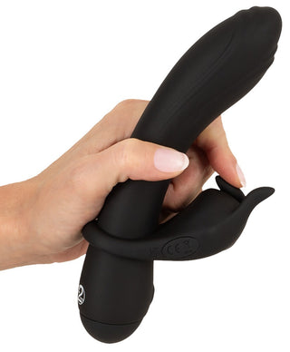 Svart silikon Duo Vibrator Couples Choice med böjt skaft och yttre stimulator, visas mot en enfärgad bakgrund.