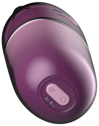 Äggformad, lila klitorisstimulator i silikon med en rosa knapp och metallkontakter.