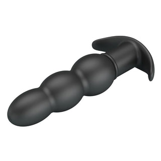 Svart analplugg i mjuk silikon med 10 vibrationslägen och utfluten bas, placerad mot vit bakgrund.