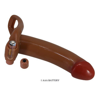 Brun, ihålig strap-on-dildo med röd spets, batteridriven, med öppet fack för ett AAA-batteri.
