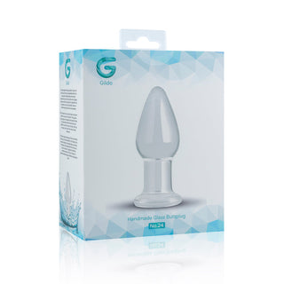En låda som visar den genomskinliga Gildo Klar Glaspluggen, tillverkad av kroppssäkert glas, märkt som en Handgjord Glass Butt Plug No. 24, mot en vit bakgrund.