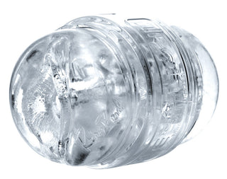 Närbild av ett genomskinligt, strukturerat plastobjekt som liknar en Fleshlight Quickshot - Riley Reid, med en cirkulär form och detaljerade gravyrer.