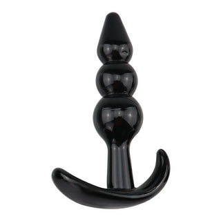 T-Plug 08 Buttplug 9 cm är en svart, nybörjarvänlig analplugg tillverkad av graderad silikon och har ett böjt handtag vid basen.